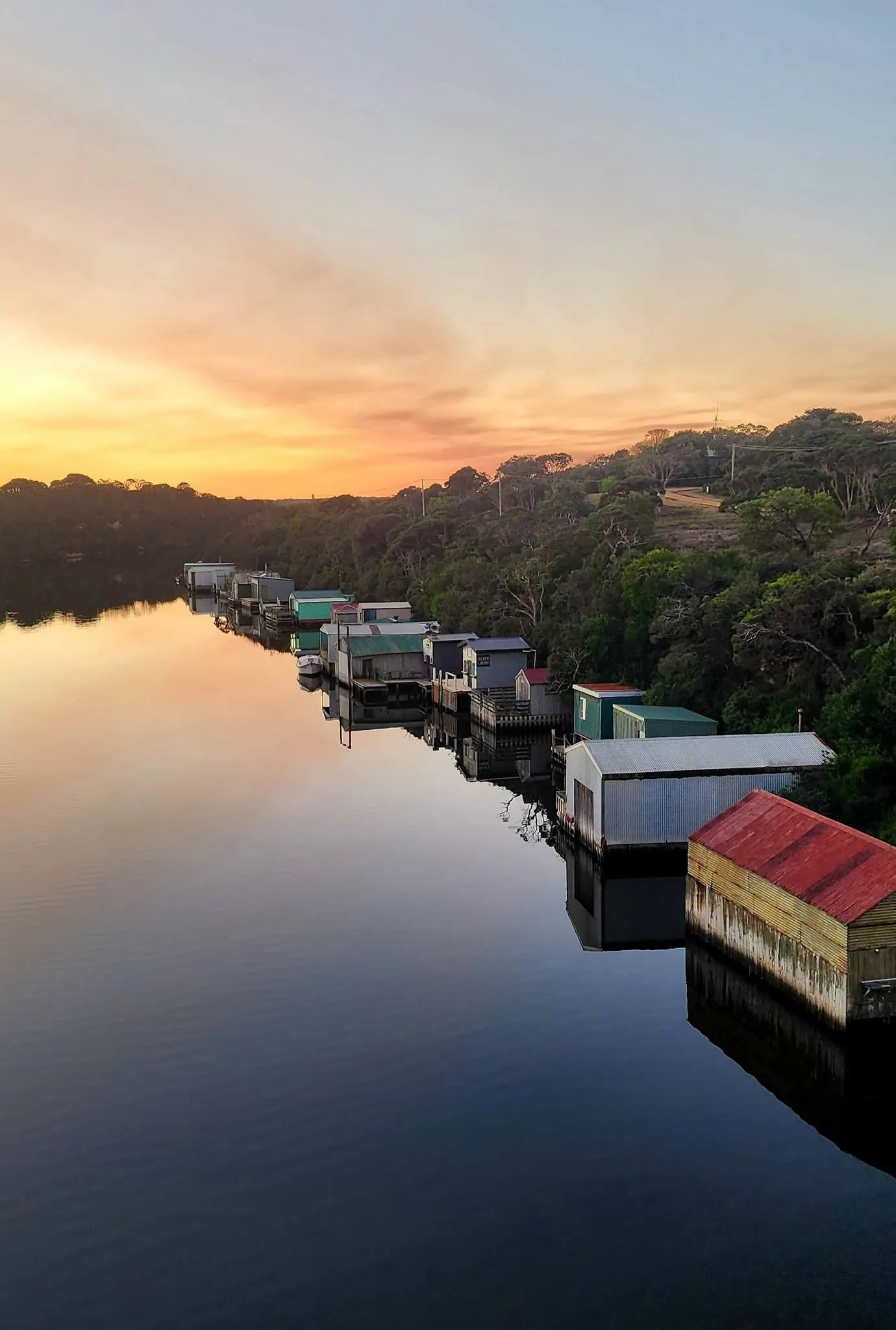 Nelson's boat sheds reflected in the Glenelg River at sunset