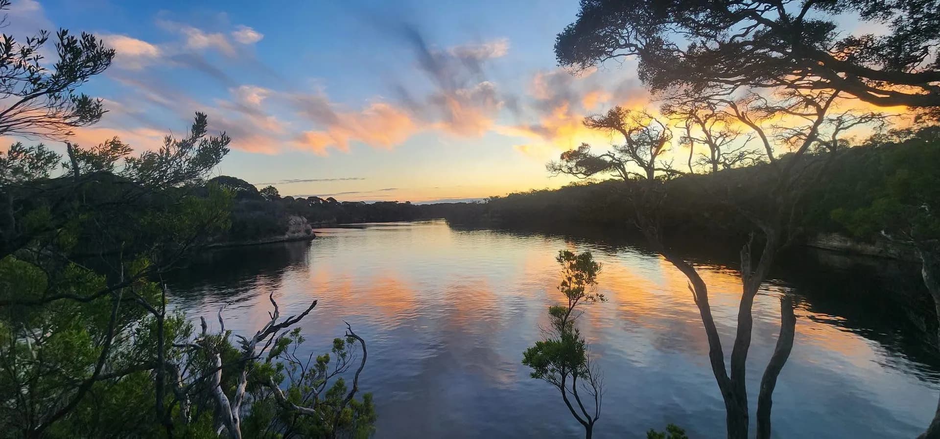 Sunset over the Glenelg River with cloud reflected in still water